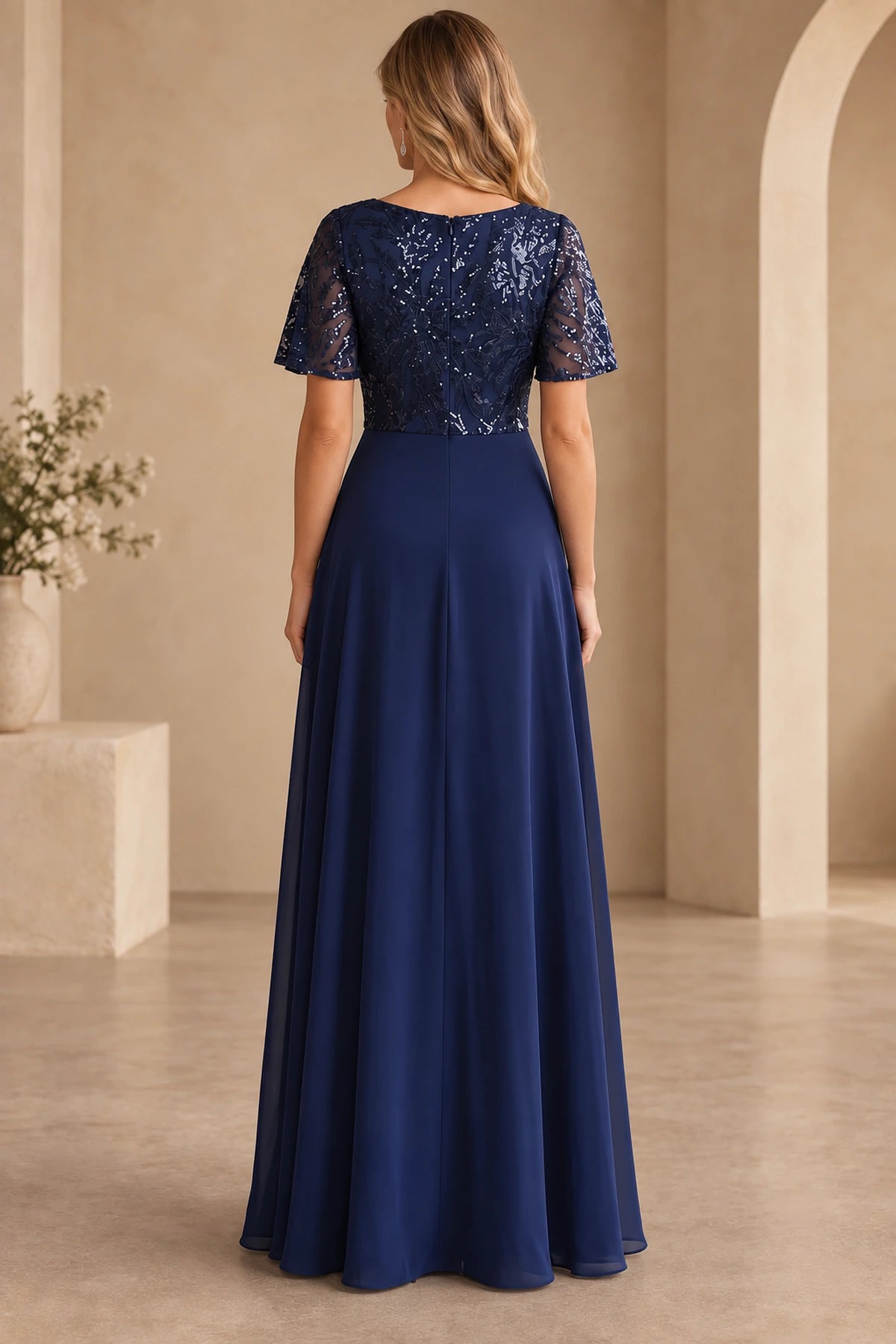 Back view of navy Mother of the Bride Dress with sequin bodice, short sleeves, center zipper and flowing A-line skirt