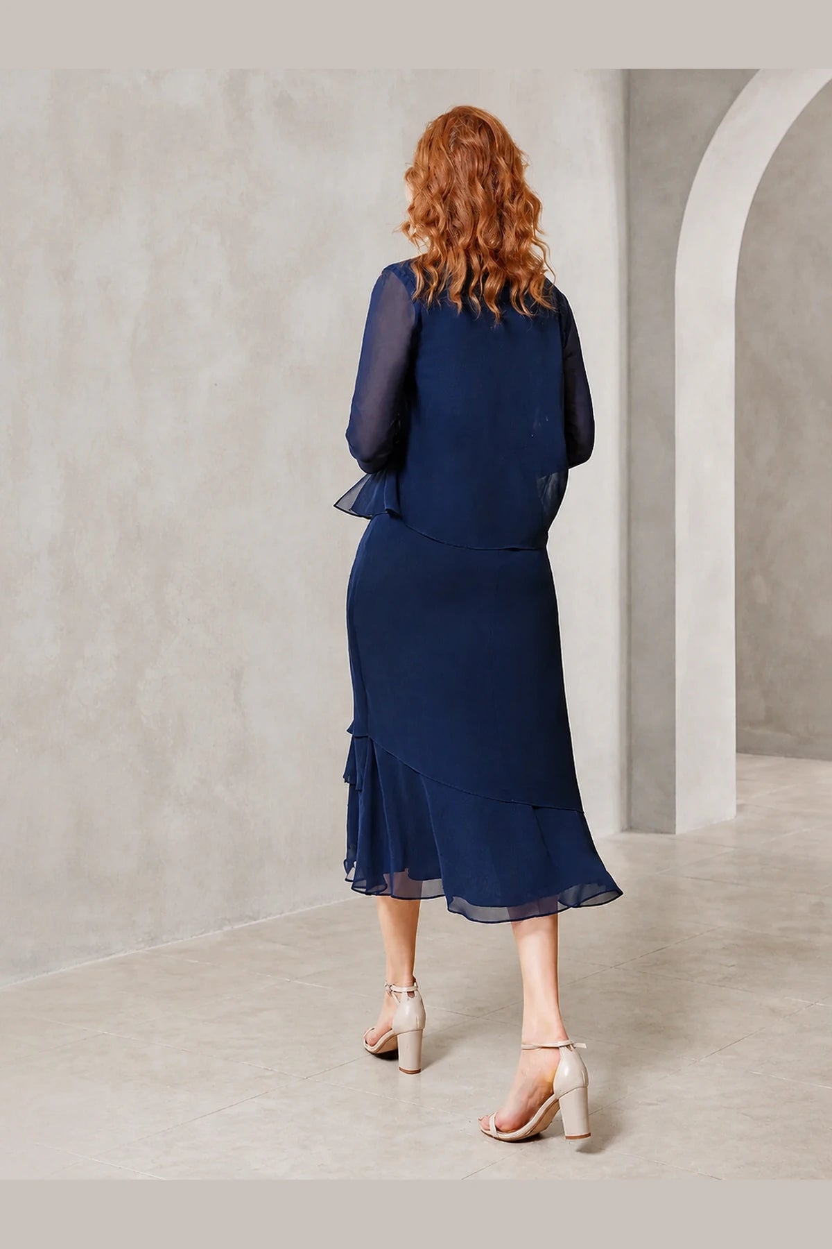 Vedress navy mother of the bride dress with sheer sleeves modest back flowing overlay and layered midi skirt back view