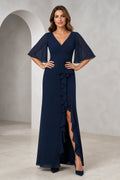 Front and back view of a navy mother of the bride dress with V-neck, sheer flutter sleeves, ruched bodice, cascading ruffle front slit, V-back, and floor-length silhouette