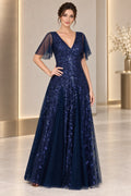 Navy mother of the bride dress with V neckline flutter sleeves sequined leaf overlay and floor length A-line skirt