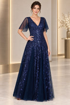 Navy mother of the bride dress with V neckline flutter sleeves sequined leaf overlay and floor length A-line skirt