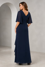 Front and back view of a navy mother of the bride dress with V-neck, sheer flutter sleeves, ruched bodice, cascading ruffle front slit, V-back, and floor-length silhouette