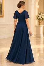 Navy mother of the bride dress with V back flutter sleeves zipper closure and flowing floor length skirt