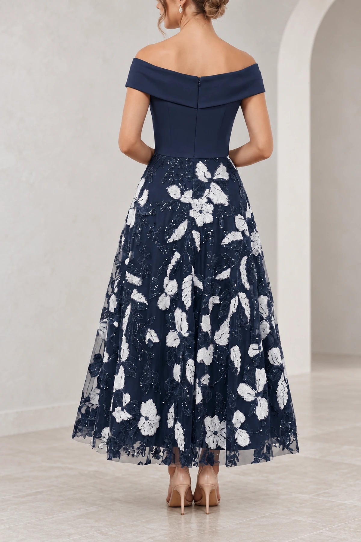 Back view of navy and white Mother of the Bride Dress with off-the-shoulder neckline, center zipper and embroidered A-line skirt