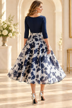 Back view of navy floral Mother of the Bride Dress with closed neckline and tea-length A-line skirt