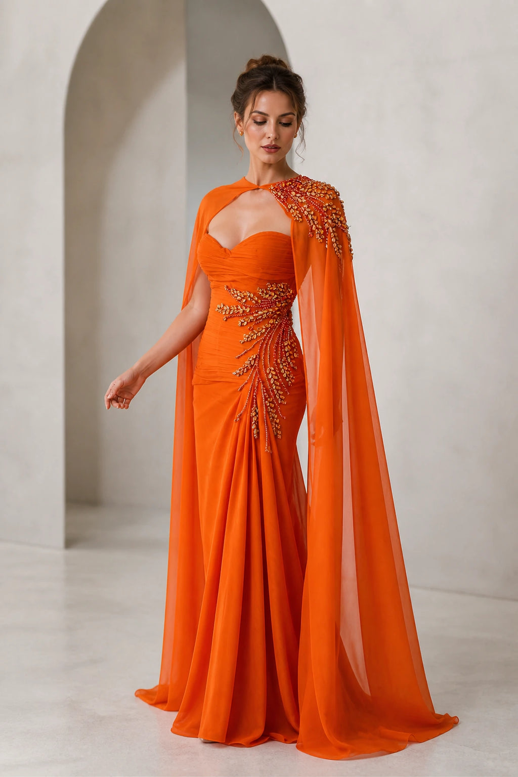 GraceProm orange evening dress with sweetheart neckline embellished waist draped cape and floor length silhouette