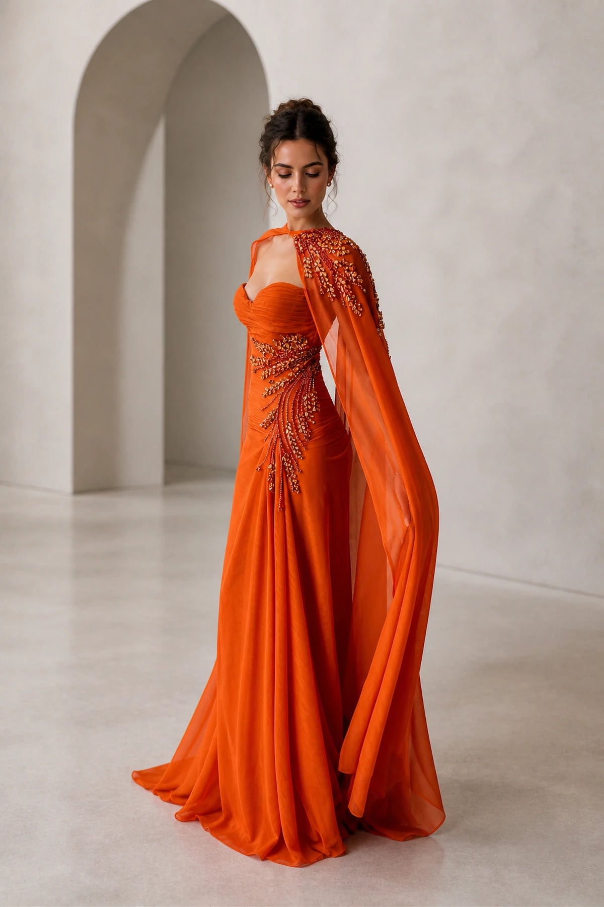 GraceProm orange evening dress with embellished shoulder cape drape and fitted floor length silhouette