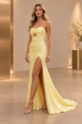 Pale yellow strapless mermaid prom dress with a sweetheart neckline, twisted ruched bodice, front cutout, sparkle and high slit.