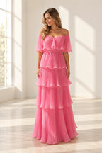 Pink pleated chiffon A-line wedding guest dress with off shoulder neckline, flutter sleeves, tiered ruffle skirt and floor length hem by Graceprom
