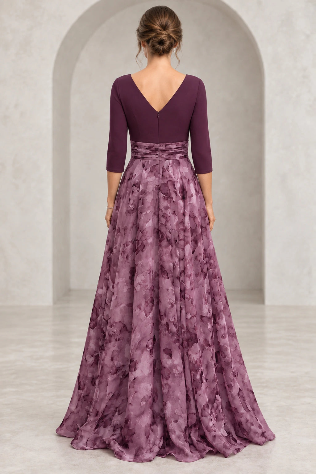 Back view of plum Mother of the Bride Dress with V-back, 3/4 sleeves, defined waist, and flowing floral floor-length skirt