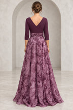 Back view of plum Mother of the Bride Dress with V-back, 3/4 sleeves, defined waist, and flowing floral floor-length skirt