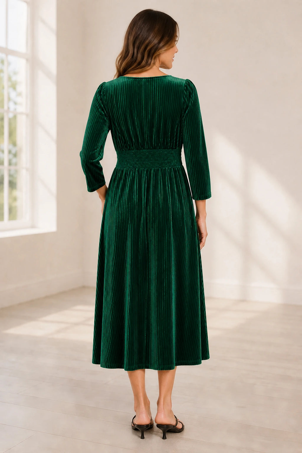 Plus size emerald green velvet mother of the bride dress with V neckline long sleeves and pleated tea length skirt