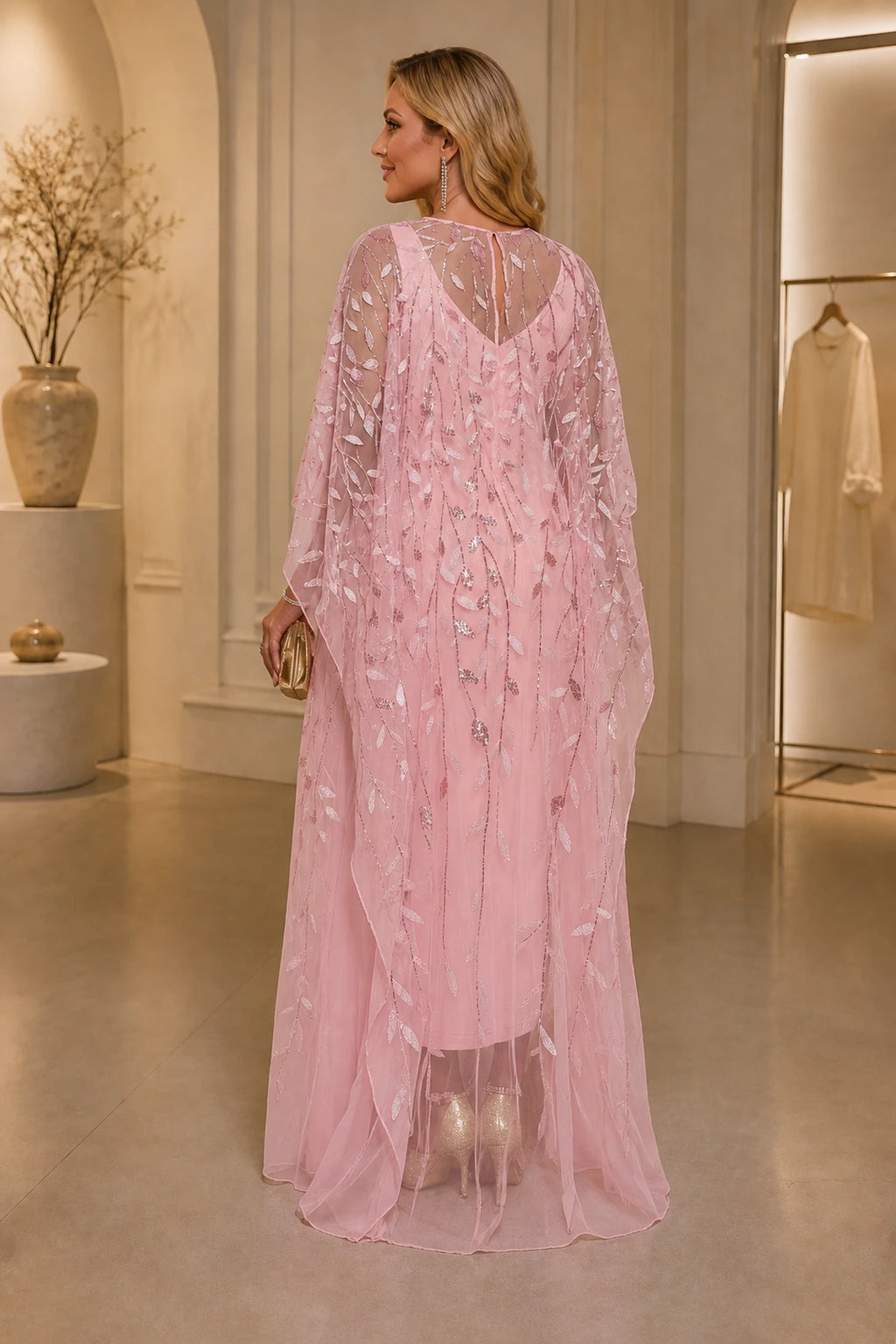 Plus size pink wedding guest dress with sheer embellished back and cape sleeves