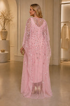 Plus size pink wedding guest dress with sheer embellished back and cape sleeves