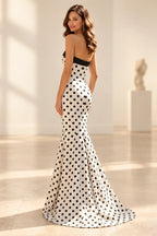 Back view of polka dot satin prom dress featuring straight strapless back, fitted mermaid silhouette and floor length sweep hem