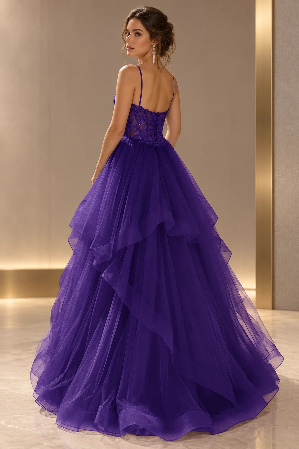 Purple prom dress with thin straps, a low sheer floral back, center zipper closure, and cascading tiered skirt.