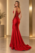 Back view of red mermaid prom dress featuring crisscross lace-up corset detailing, delicate straps, embellished floral appliques, fitted skirt, and sweeping train.