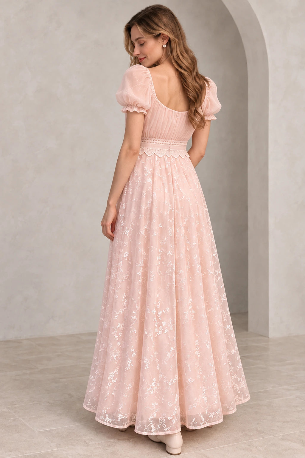 Blush pink floral tulle A-line wedding guest dress back view featuring puff sleeves, scoop back, lace waistband and flowing floor-length embroidered skirt