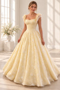 Butter yellow floral embroidered tulle prom ball gown front view with square neckline, lace flutter sleeves, fitted corset bodice and full floor-length skirt