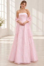 Blush pink floral tulle A-line prom dress front view featuring a strapless neckline, embroidered corset bodice, 3D floral appliques and flowing floor-length skirt