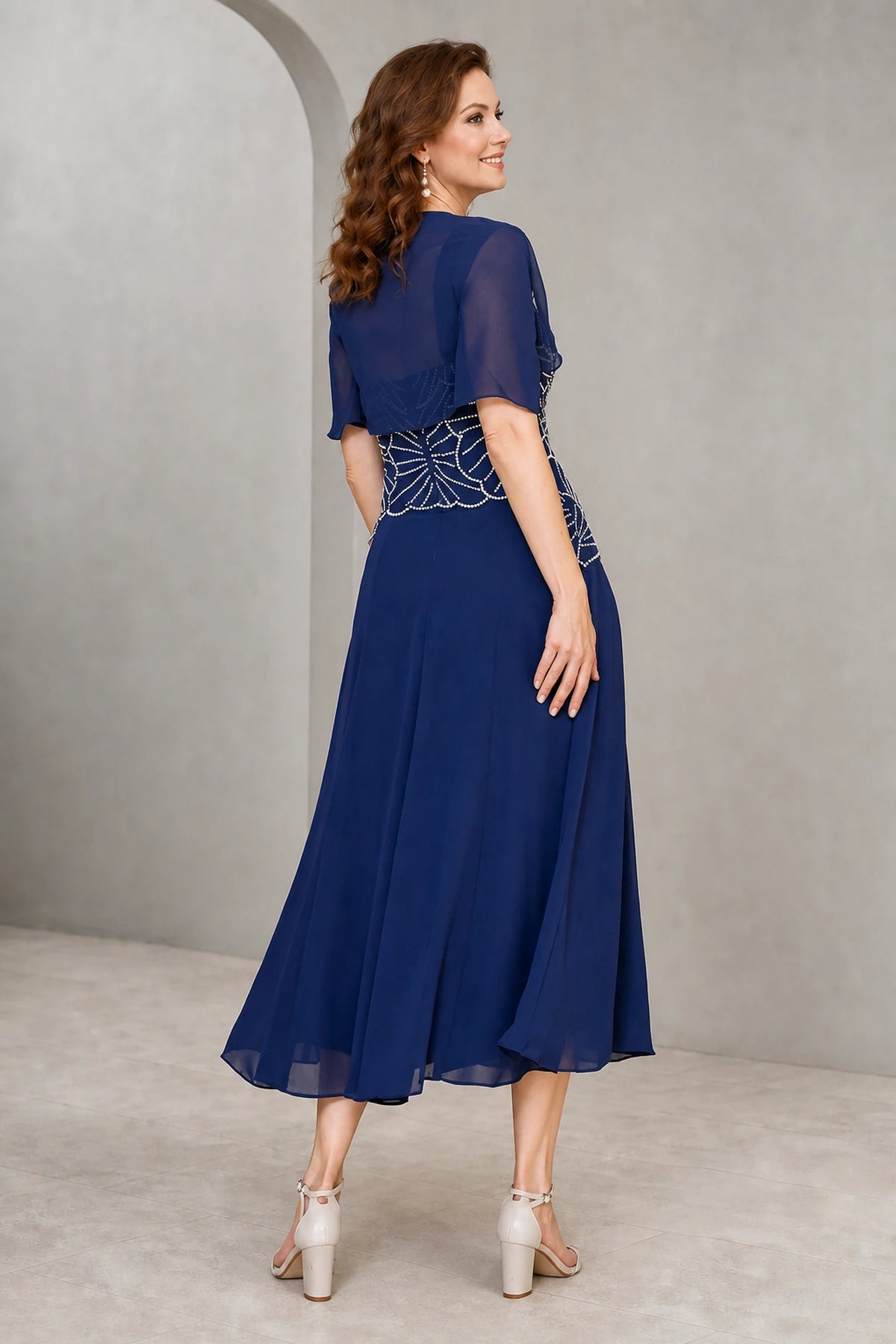 Royal blue A-line Mother of the Bride dress with square neckline, geometric beaded bodice, chiffon shrug and tea-length skirt, front and back view by Vedress