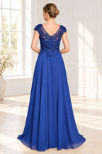 Royal blue formal dress with illusion V back lace appliqué and flowing floor length skirt