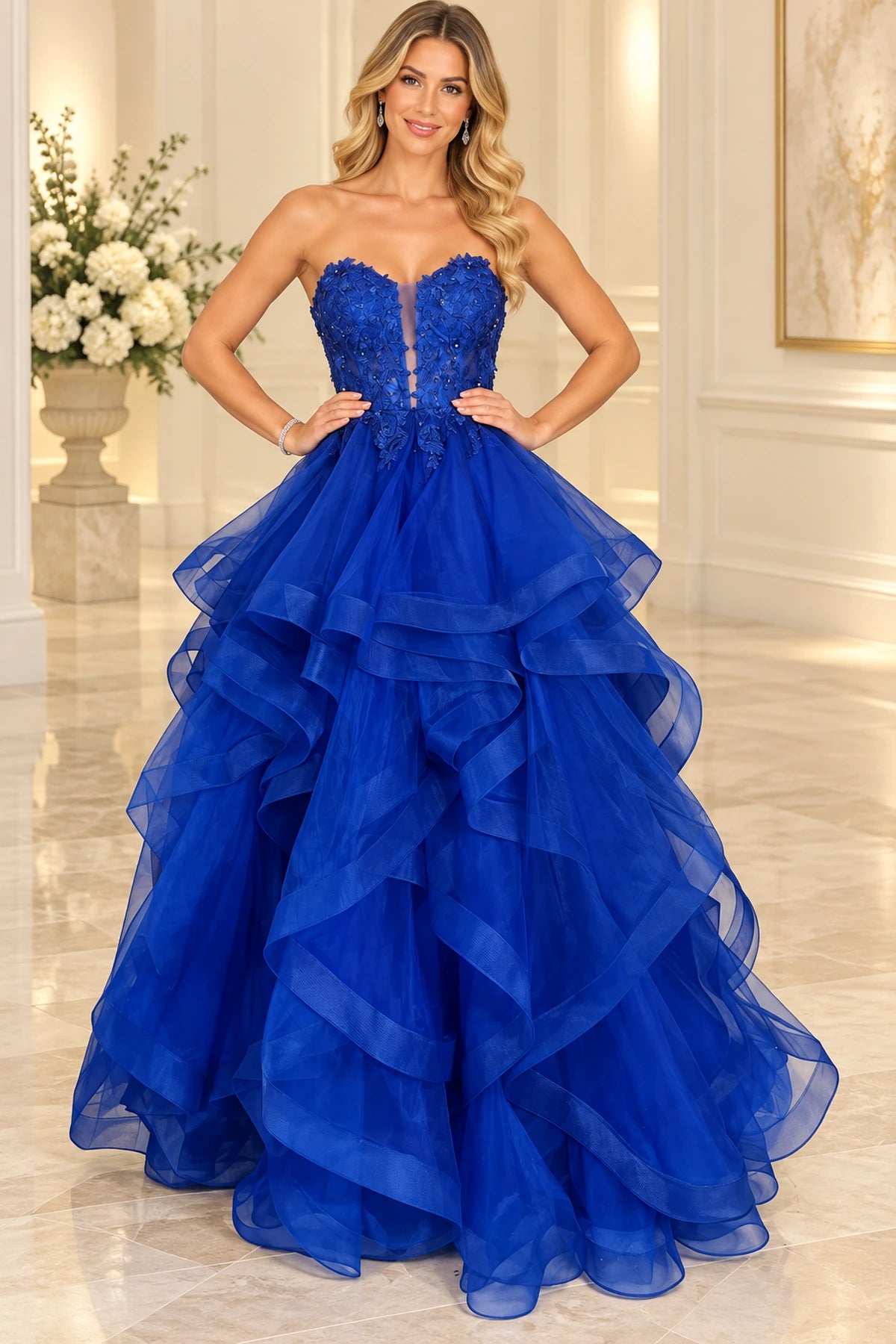 Royal blue ball gown prom dress featuring a plunging V-neckline, floral lace beaded corset bodice, spaghetti straps, and cascading tulle ruffles by Graceprom.
