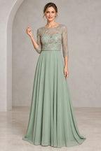 Sage green A-line mother of the bride dress with illusion neckline three-quarter sheer sleeves beaded botanical bodice and floor-length skirt