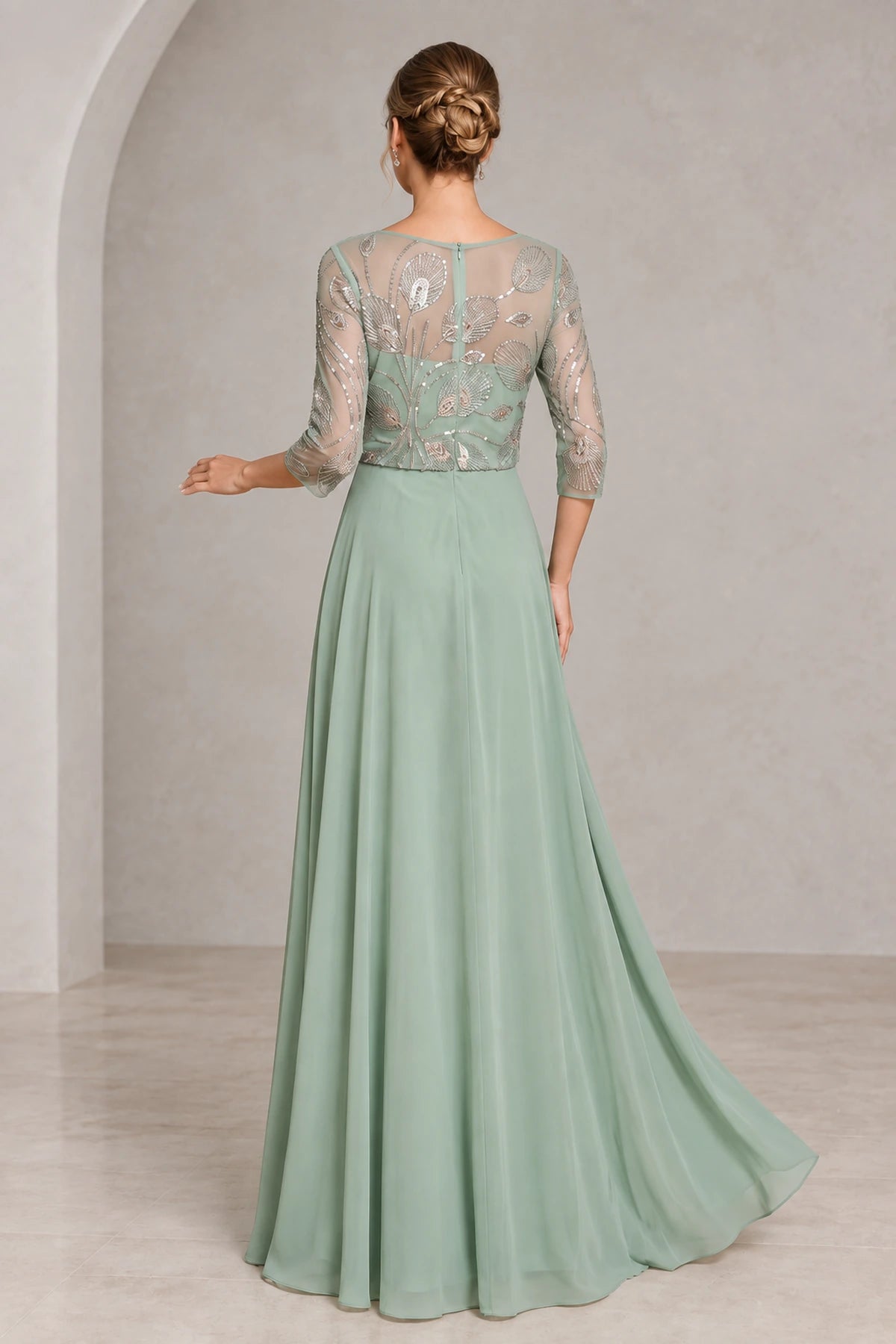 Back view of sage green mother of the bride dress with sheer beaded illusion back three-quarter sleeves center zipper and flowing A-line skirt