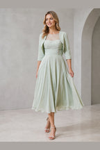 Vedress sage green mother of the bride dress with illusion neckline lace bodice bolero jacket ruched waist and midi A-line skirt front view
