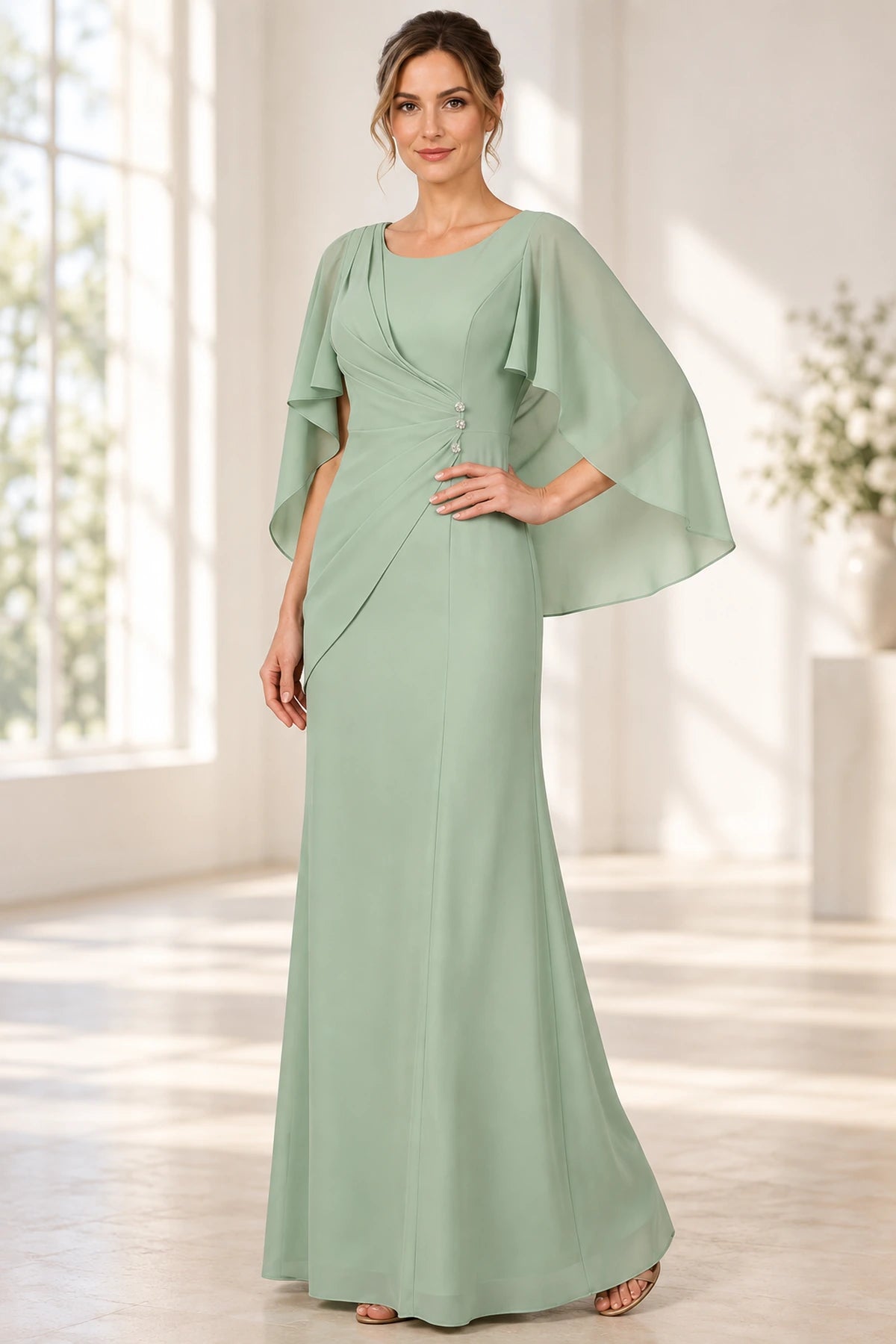 Sage green mother of the bride dress with scoop neckline cape sleeves and draped bodice