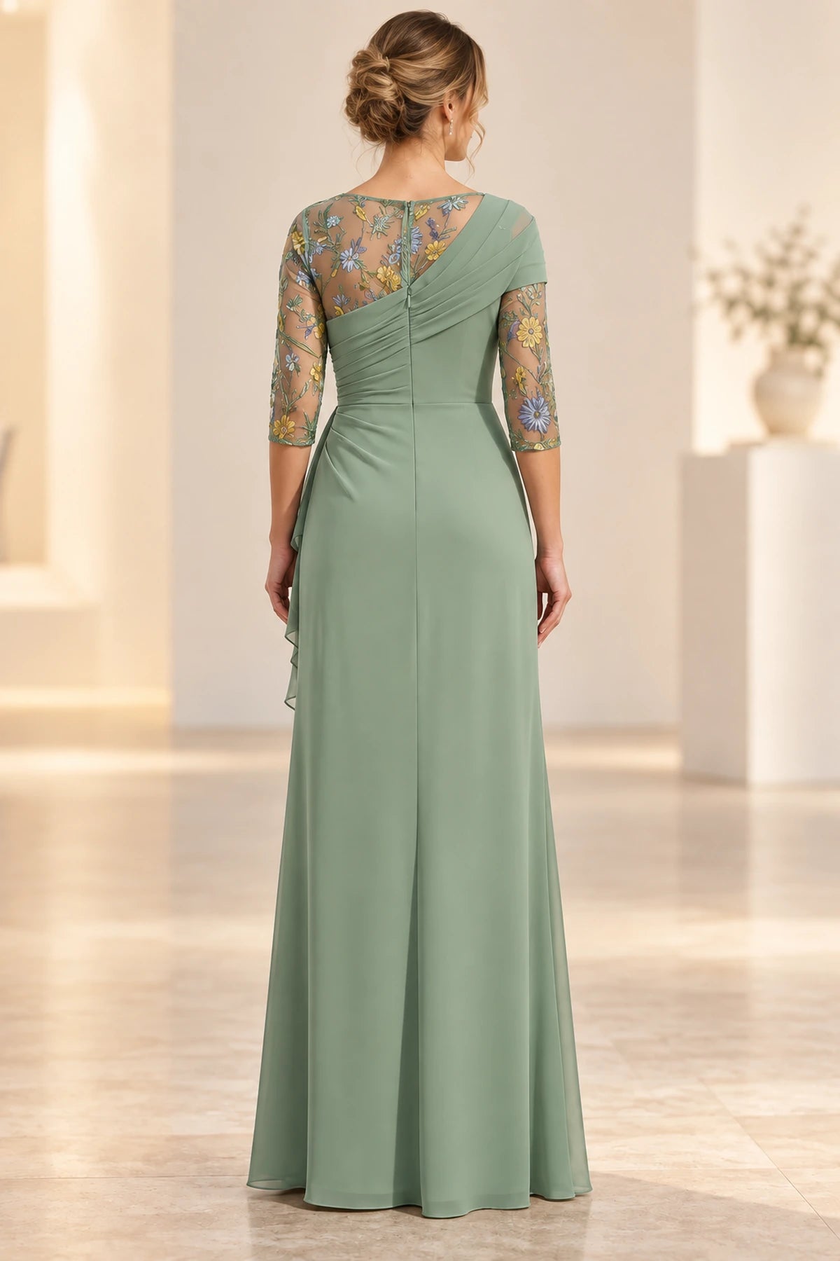 Back view of sage green Mother of the Bride Dress with sheer floral embroidery and draped bodice