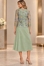 Back view of sage green Mother of the Bride Dress with closed back, multicolor floral embroidery and tea-length A-line skirt