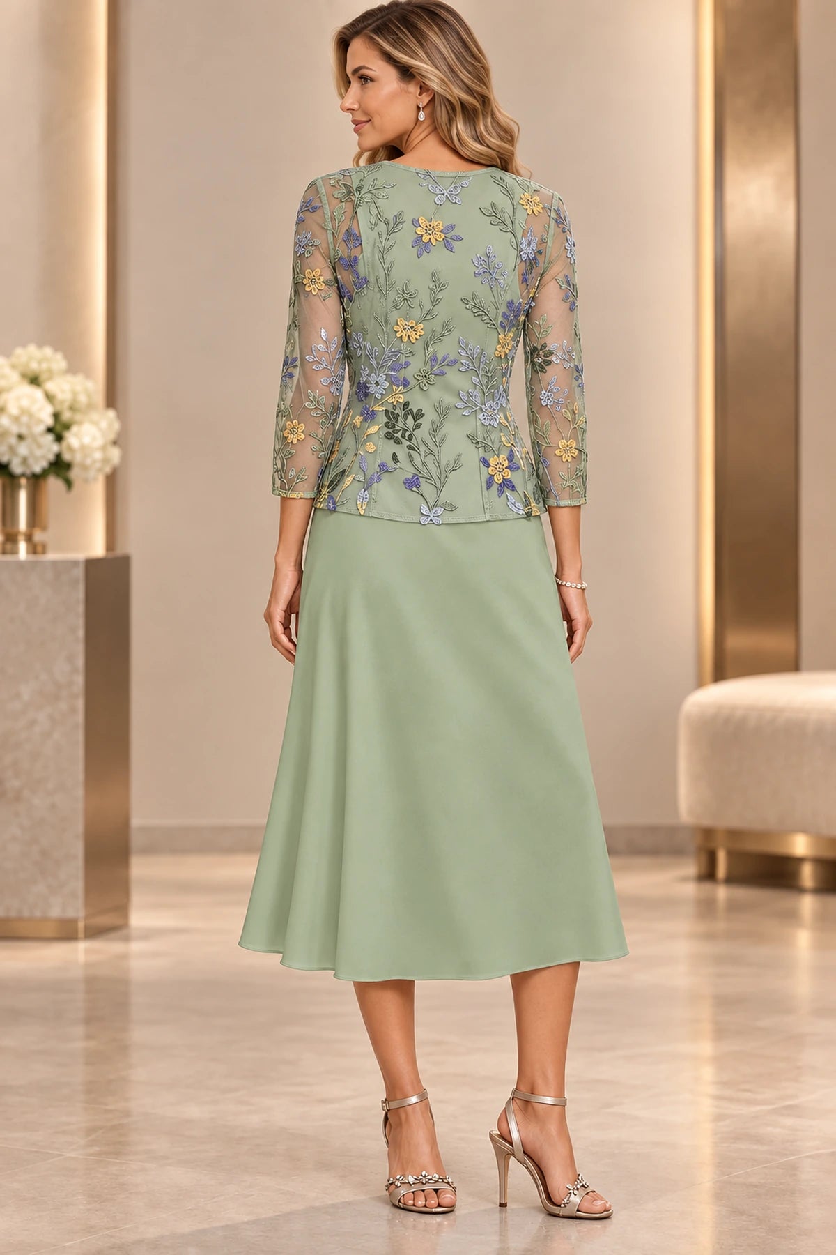 Back view of sage green Mother of the Bride Dress with closed back, multicolor floral embroidery and tea-length A-line skirt