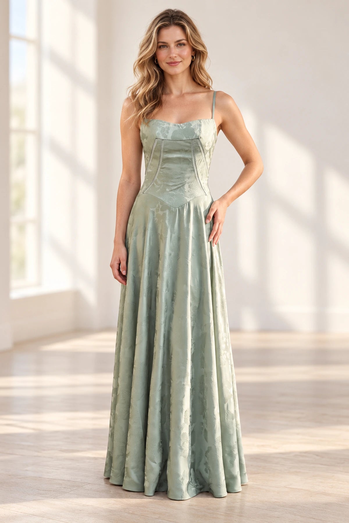 Sage green A-line prom dress with square neckline, spaghetti straps, structured corset bodice, floral jacquard pattern and floor-length skirt.