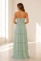 Back view of sage green bridesmaid dress with strapless zip back and pleated tiered A-line skirt