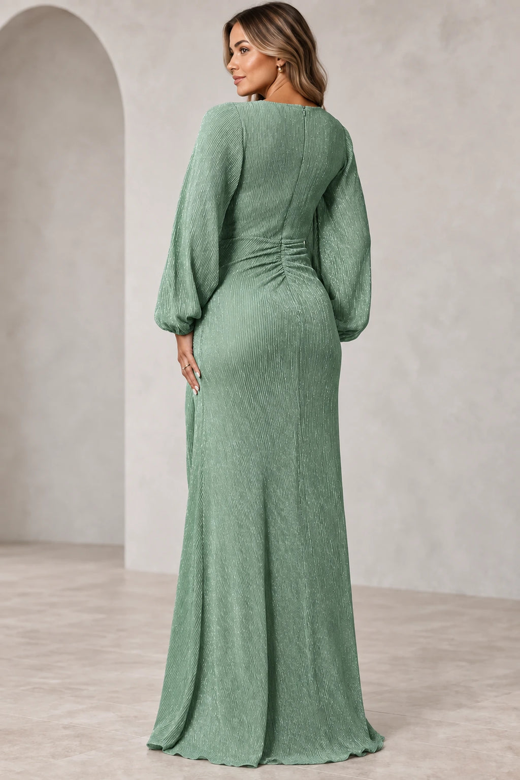 Back view of sage green Mother of the Bride Dress with long sleeves, gathered waist and flowing floor-length skirt