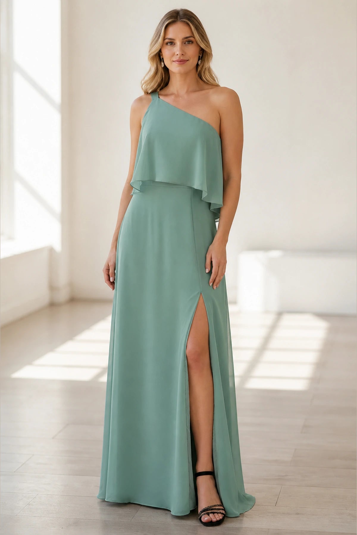 Sage green wedding guest dress with one-shoulder neckline, ruffle overlay, high slit and floor-length A-line skirt front view