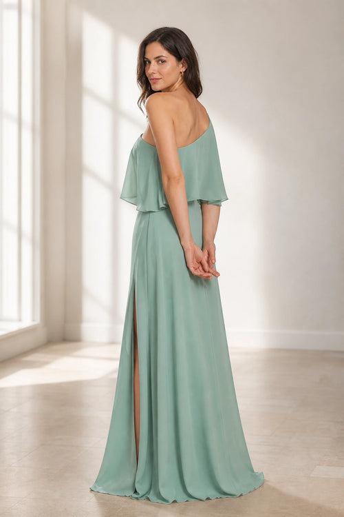 Sage green floor-length wedding guest dress with asymmetric one-shoulder back and flowing ruffle overlay back view