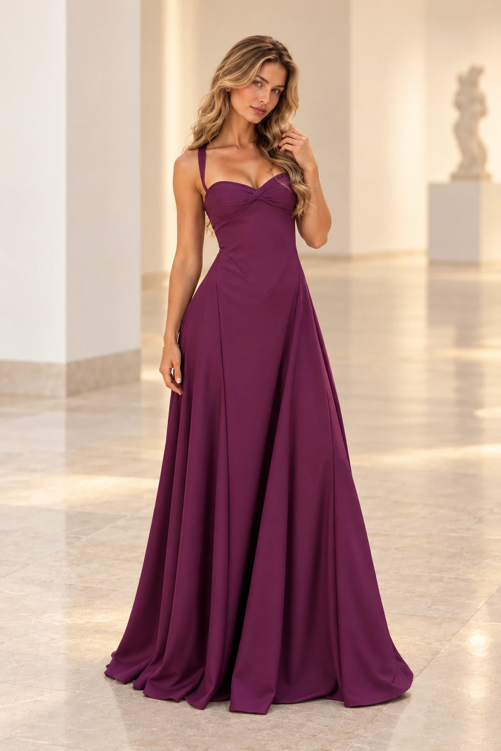 Plum purple satin A-line bridesmaid dress with sweetheart-inspired neckline, spaghetti straps, crossed ruched bodice and flowing floor length skirt by Graceprom