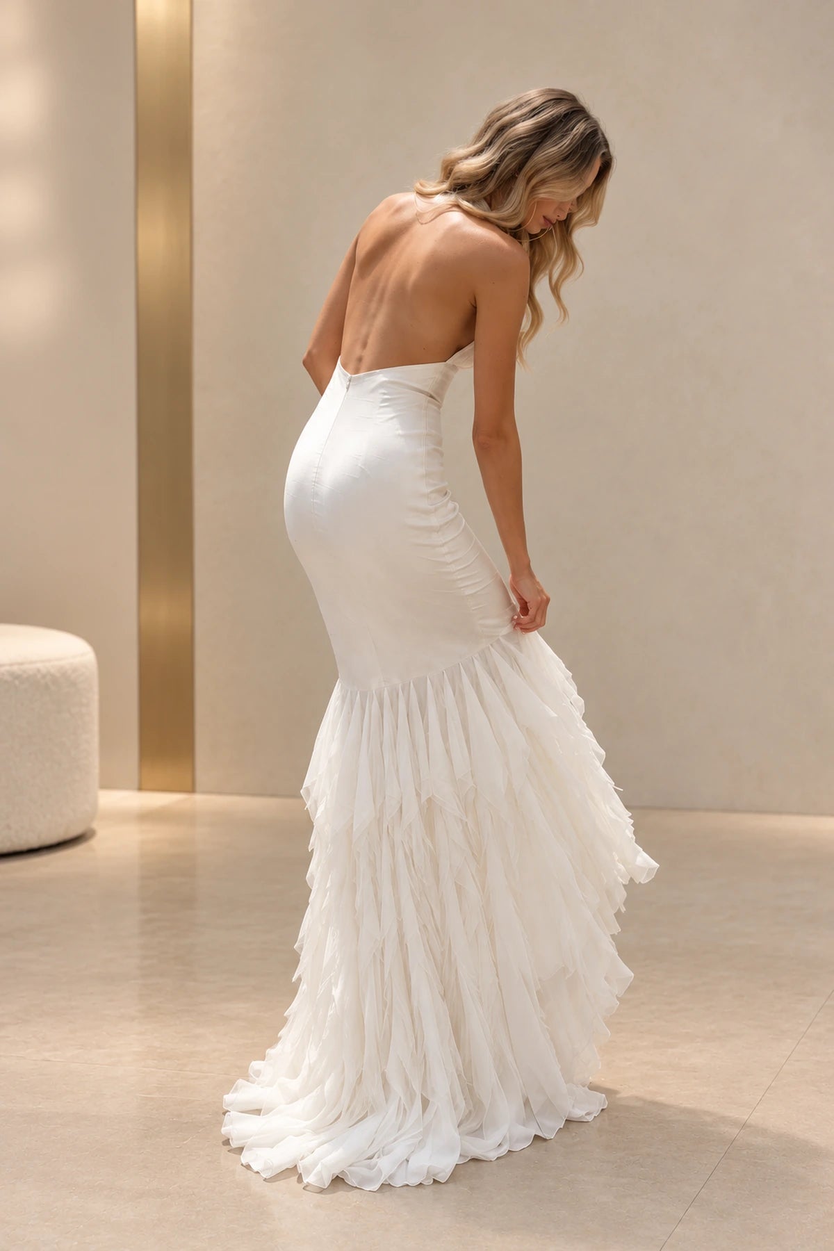 Back view of an ivory Graceprom satin and chiffon prom dress with a low open back, center zipper and layered chiffon mermaid skirt.