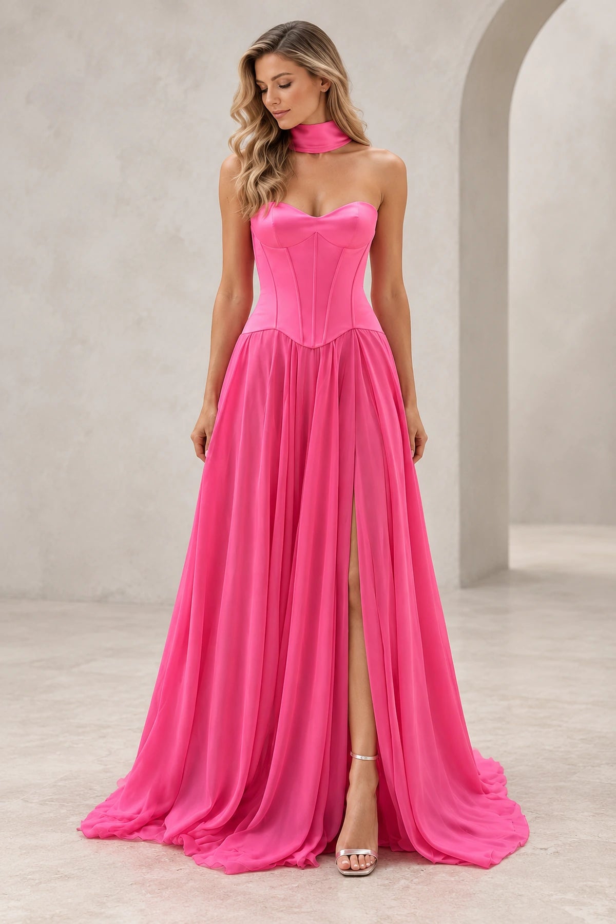 Front view of a hot pink Graceprom prom dress with a satin sweetheart corset bodice, pointed basque waist and high-slit chiffon A-line skirt.