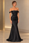 Black satin mermaid prom dress with off shoulder neckline, ruched fitted bodice, defined waist and flowing floor length flared skirt by Graceprom