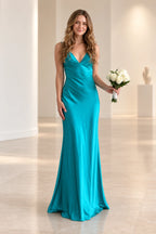 Teal satin mermaid bridesmaid dress with deep V neckline, sleeveless fitted bodice, defined waist and flowing floor length skirt by Graceprom