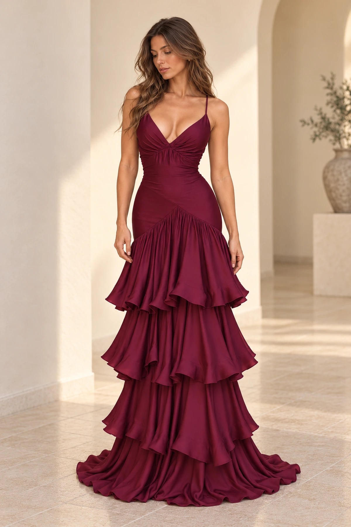 Burgundy satin mermaid prom dress with plunging V neckline, spaghetti straps, ruched fitted bodice and cascading tiered ruffle skirt by Graceprom