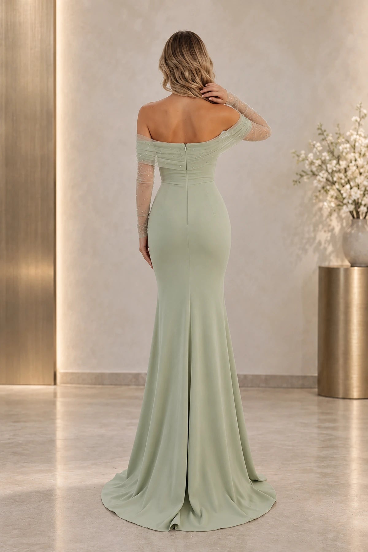 Back view of a sage green Graceprom satin evening dress with a low neckline, center-back zipper, sheer pearl-detail sleeves and flared mermaid skirt.