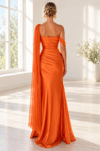 Back view of an orange Graceprom satin prom dress with a straight back neckline, center zipper, ruched hips and a long sheer shoulder drape.