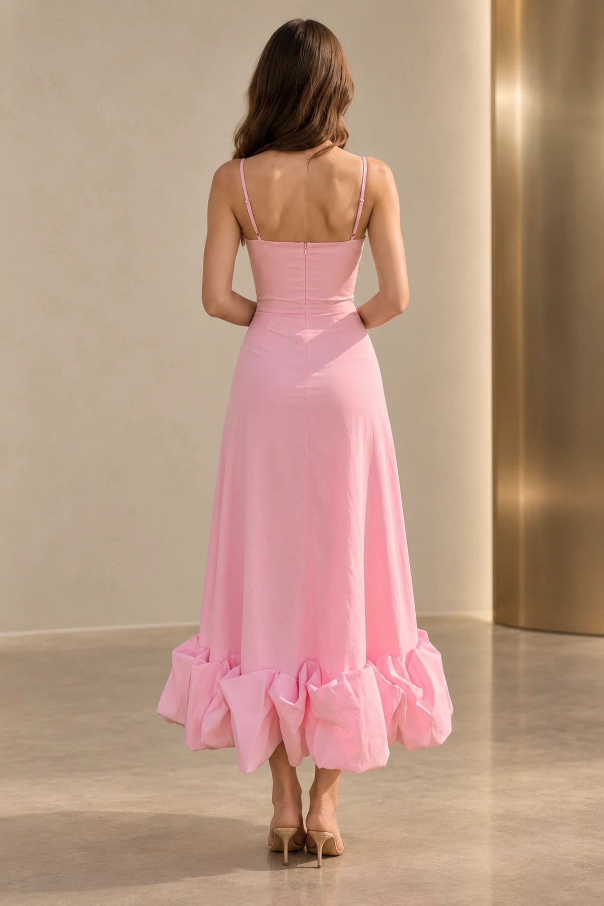 Back view of a pink Graceprom satin wedding guest dress with adjustable straps, a low straight back, center zipper and ankle-length ruffle skirt.