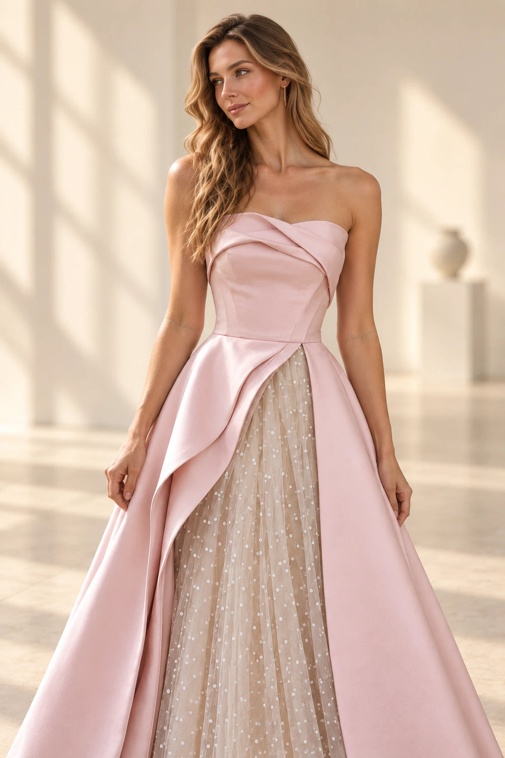Blush pink satin and sequin tulle A-line prom dress with strapless sweetheart neckline, draped bodice, asymmetrical sparkling skirt and floor-length hem by Graceprom