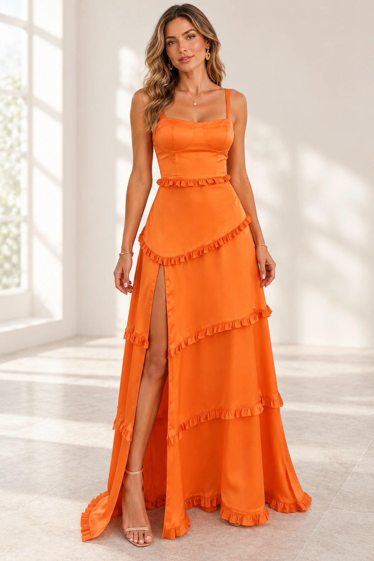 Front view of an orange Graceprom satin prom dress with a square-neck corset-style bodice, ruffle-edged skirt tiers and a high front slit.